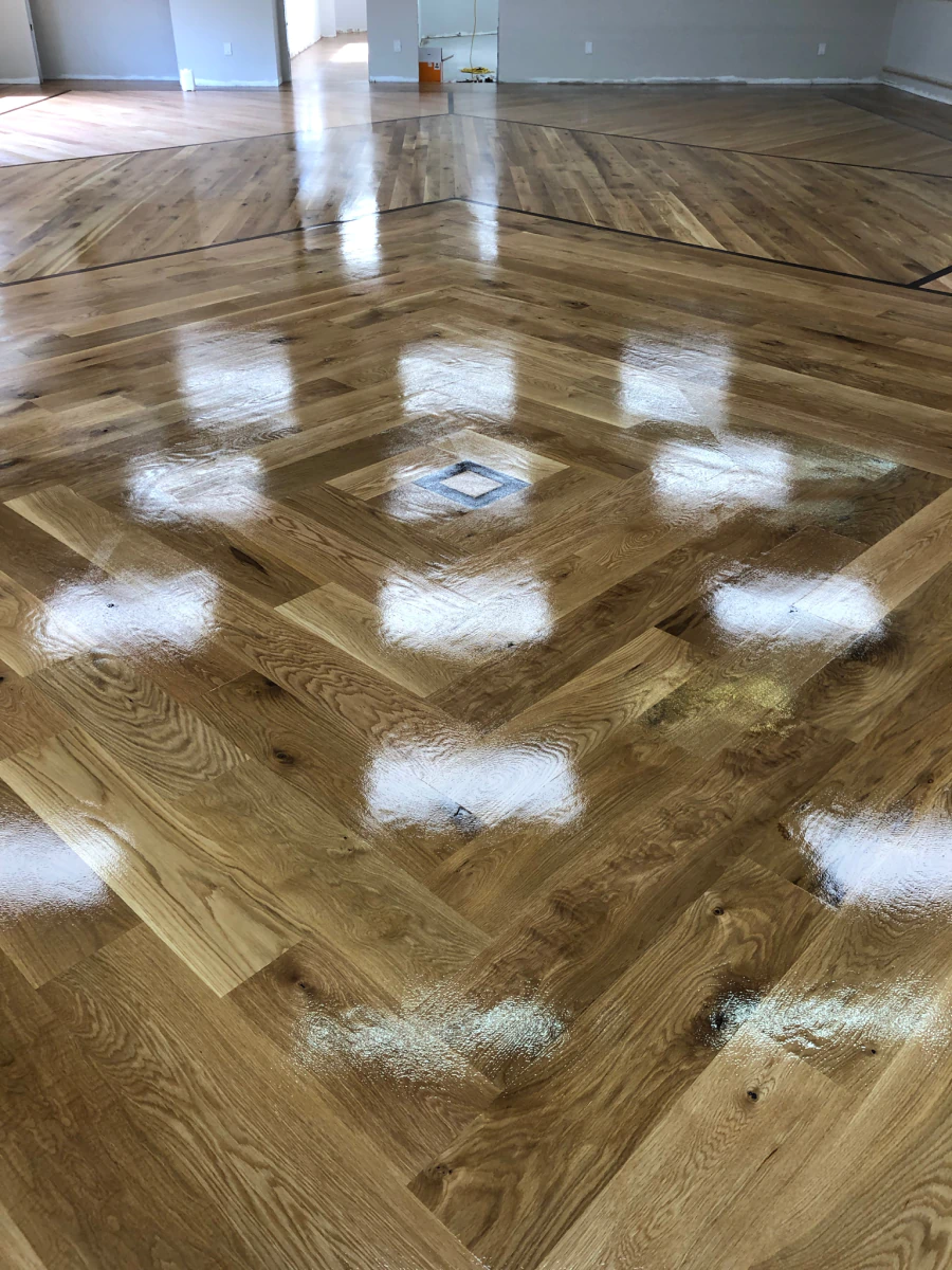 Vinyl plank floor being repaired near a kitchen island