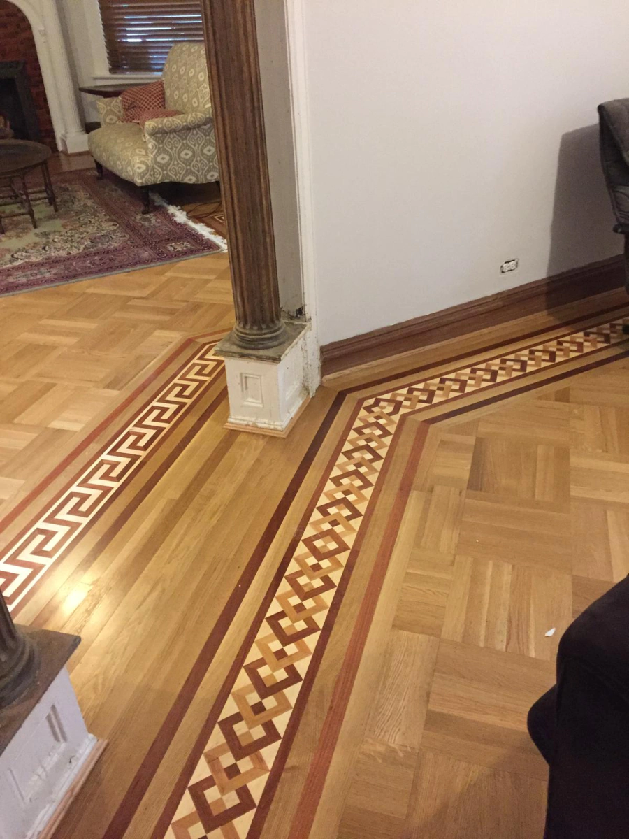 Laminate plank being replaced during a floor repair