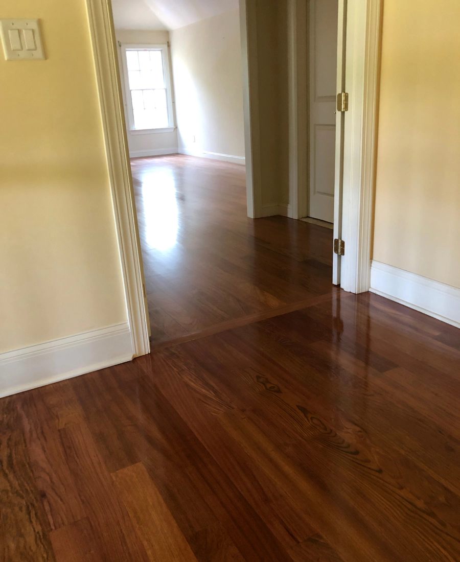 Old flooring removed and new hardwood being installed in its place